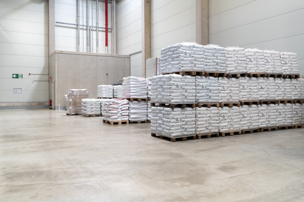 Paletten mit verpackter Ware in einer sauberen, großzügigen Lagerhalle.